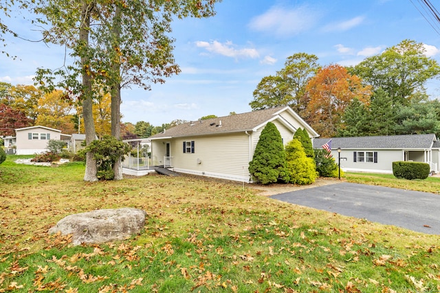 view of side of home featuring a lawn