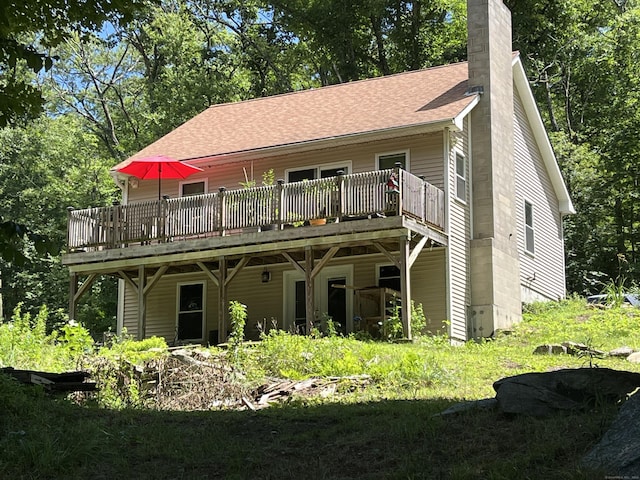 back of property featuring a wooden deck