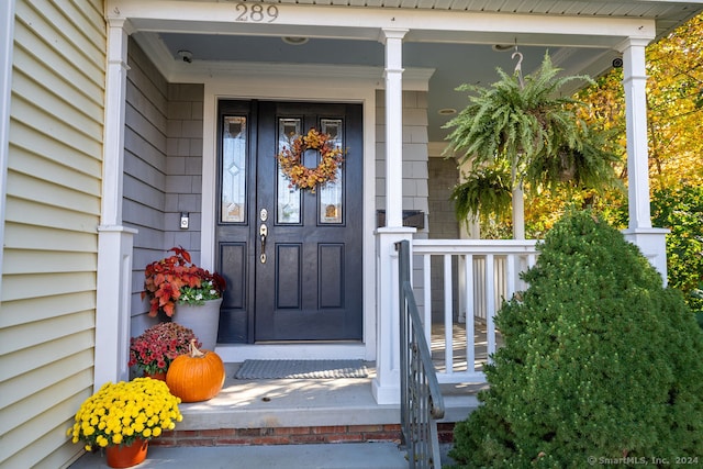 view of exterior entry with a porch