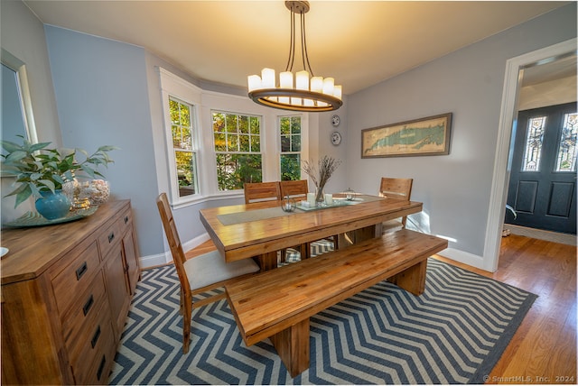 dining area featuring light hardwood / wood-style flooring and a notable chandelier