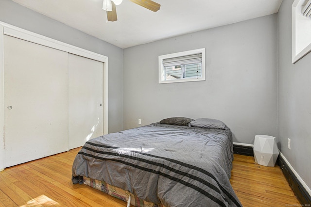 bedroom featuring ceiling fan, a closet, and light hardwood / wood-style floors