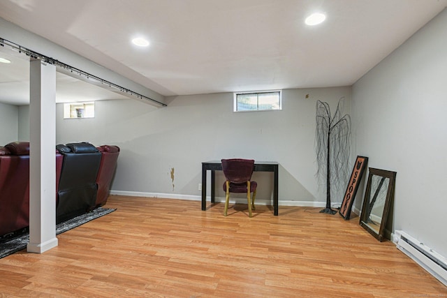 office space featuring light hardwood / wood-style flooring and a baseboard heating unit