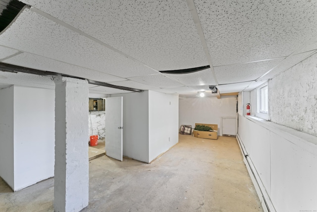 basement with a paneled ceiling