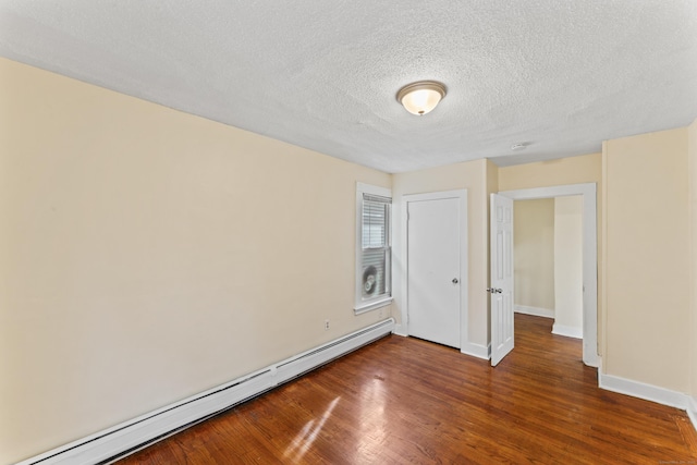 unfurnished bedroom with dark hardwood / wood-style floors, a textured ceiling, and a baseboard radiator