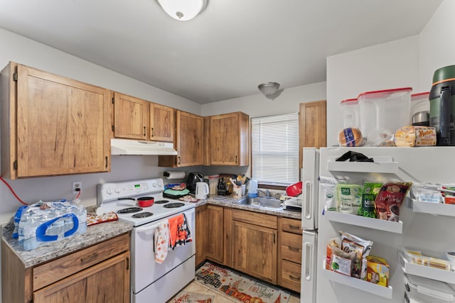 kitchen featuring white appliances and sink