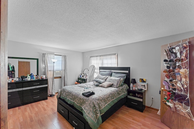 bedroom with a textured ceiling and hardwood / wood-style floors