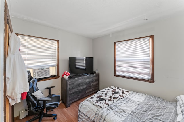 bedroom featuring cooling unit and light wood-type flooring