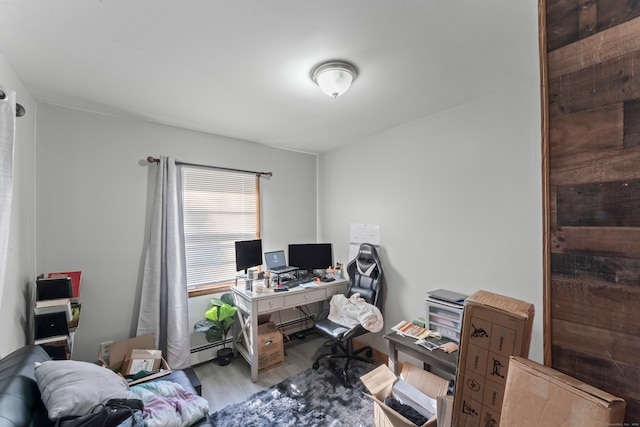 office with light hardwood / wood-style flooring and baseboard heating