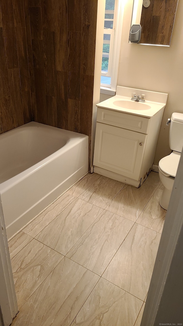 bathroom featuring vanity, toilet, and a bathing tub