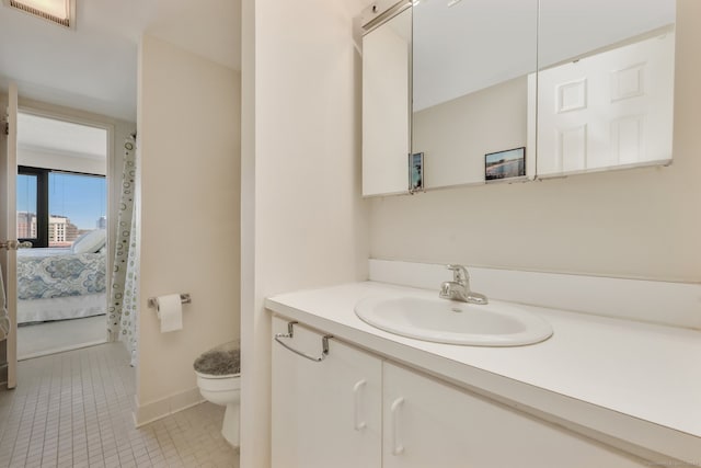 bathroom with vanity, toilet, and tile patterned floors