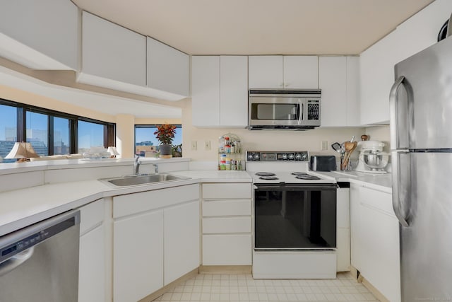 kitchen with sink, appliances with stainless steel finishes, and white cabinets