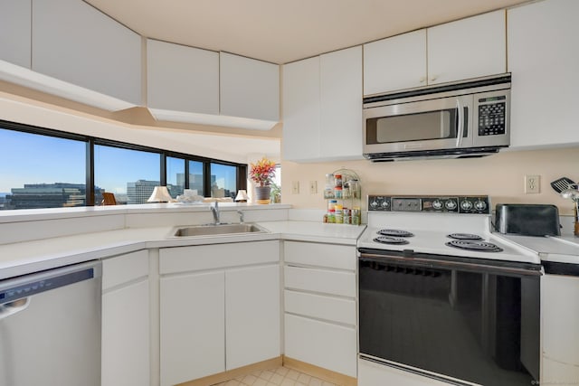 kitchen featuring light tile patterned floors, stainless steel appliances, sink, and white cabinets