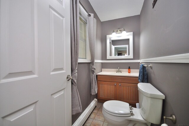 bathroom featuring vanity, tile patterned floors, toilet, and a baseboard radiator