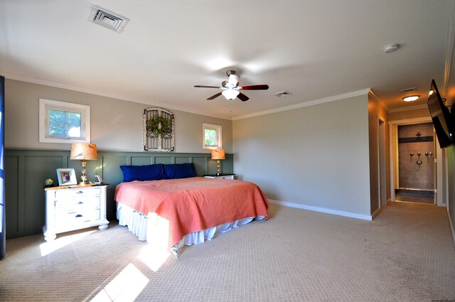 carpeted bedroom featuring ornamental molding, multiple windows, and ceiling fan