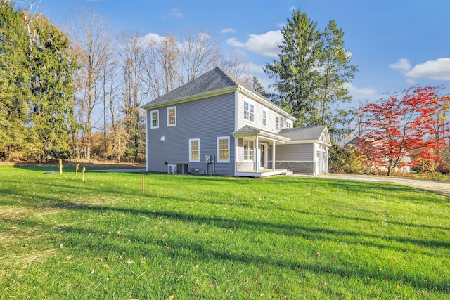 view of side of home featuring a deck, a lawn, and central AC unit