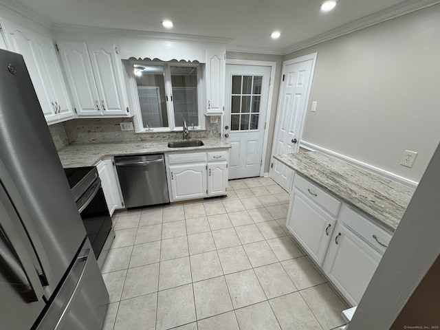 kitchen featuring sink, white cabinetry, crown molding, tasteful backsplash, and appliances with stainless steel finishes