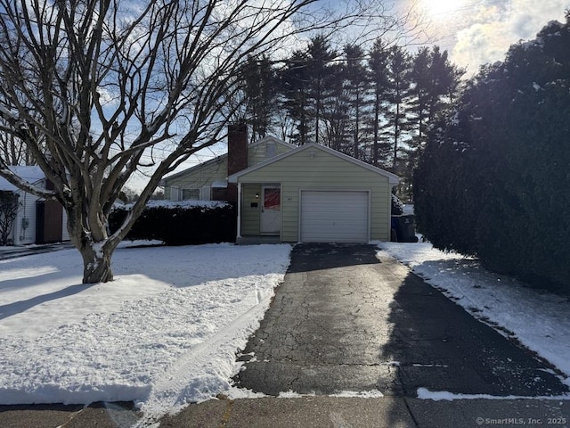 exterior space with an outbuilding and a garage