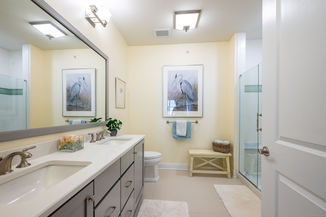 bathroom featuring vanity, toilet, tile patterned flooring, and an enclosed shower