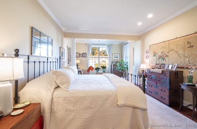 bedroom with crown molding and dark wood-type flooring