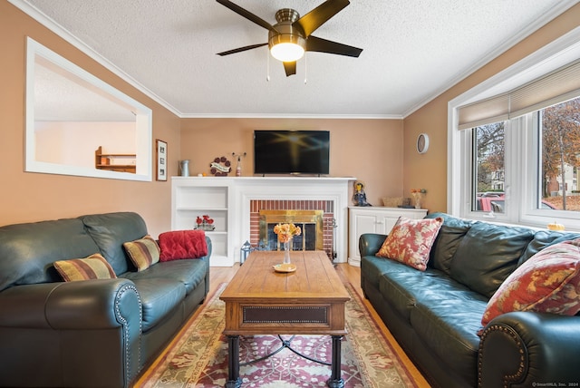 living room with crown molding, a brick fireplace, and a textured ceiling