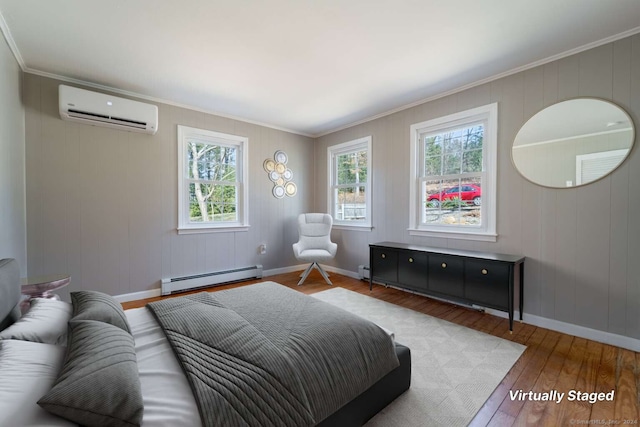 bedroom with a wall mounted air conditioner, crown molding, baseboard heating, and wood-type flooring