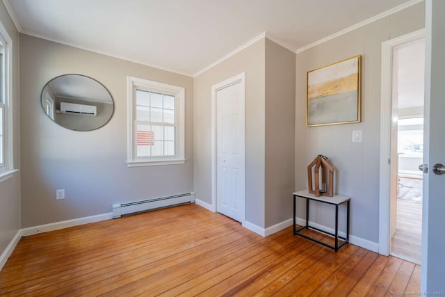 unfurnished bedroom with baseboard heating, an AC wall unit, crown molding, and light wood-type flooring