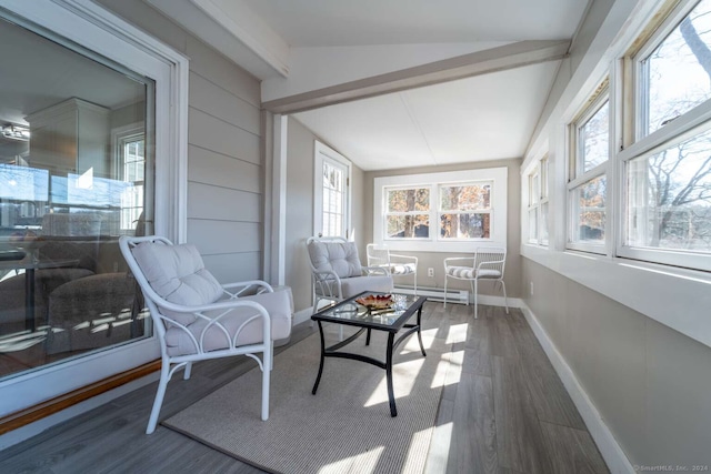 sunroom / solarium featuring baseboard heating and vaulted ceiling