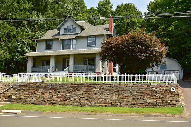 view of front of house with a porch and a garage