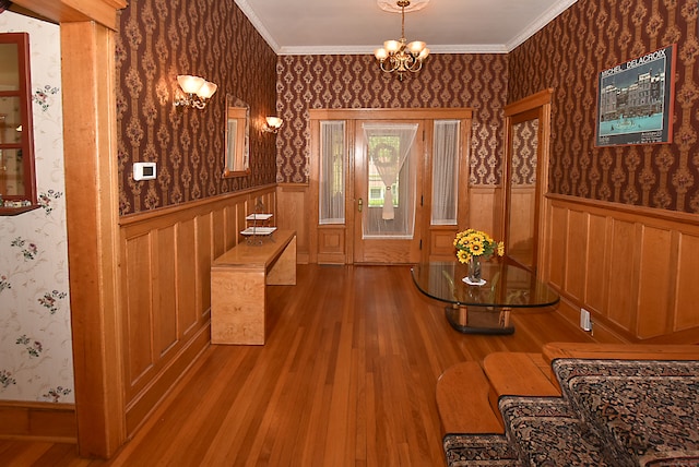 interior space featuring crown molding, a chandelier, and hardwood / wood-style floors