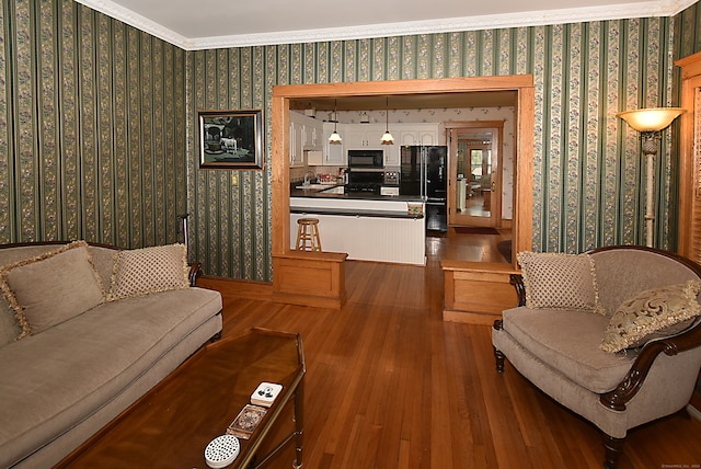 living room with sink, crown molding, and hardwood / wood-style flooring