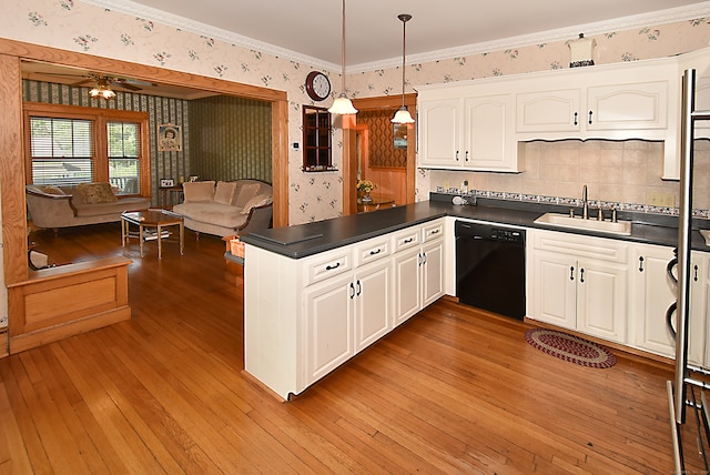 kitchen with sink, light wood-type flooring, dishwasher, kitchen peninsula, and hanging light fixtures