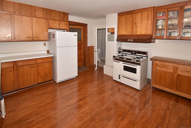 kitchen featuring white appliances and dark wood-type flooring