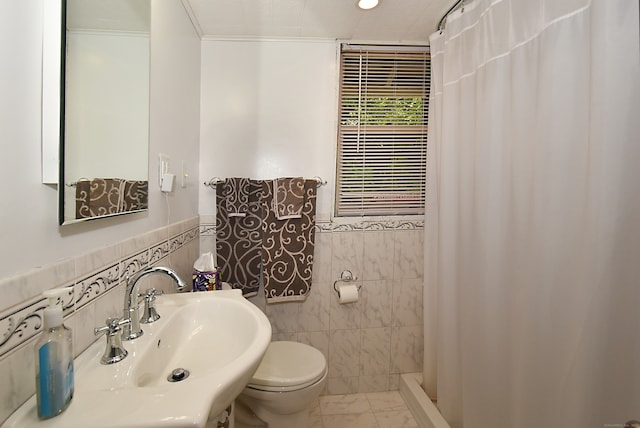 bathroom featuring toilet, a shower with shower curtain, sink, and tile walls