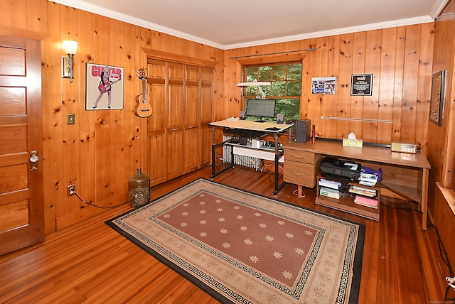 home office featuring crown molding, wood-type flooring, and wooden walls