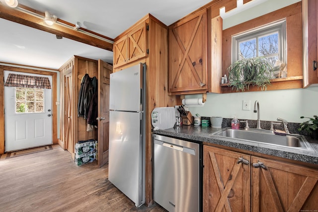 kitchen featuring light hardwood / wood-style flooring, stainless steel appliances, sink, and a wealth of natural light