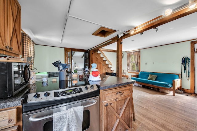 kitchen with electric range and light hardwood / wood-style floors