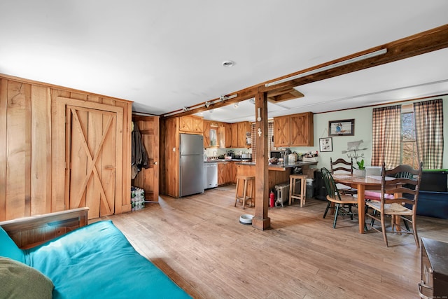 living room with wooden walls and light wood-type flooring