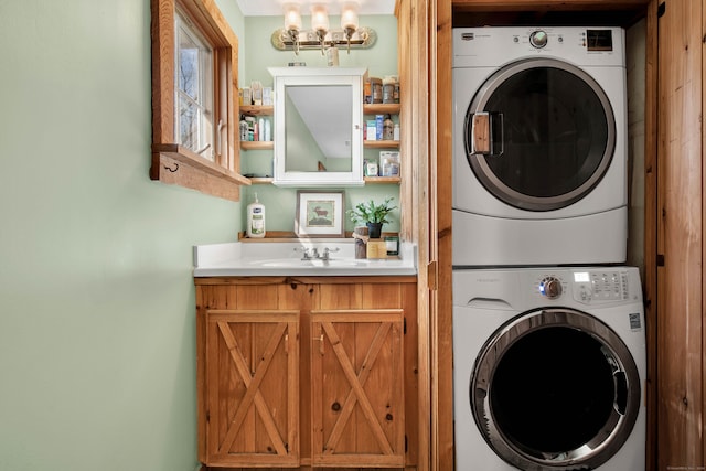 laundry room with sink, stacked washer and clothes dryer, and an inviting chandelier