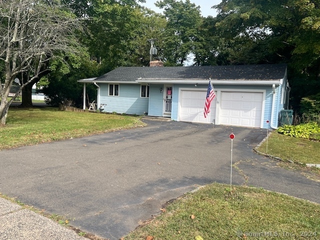 single story home featuring a front lawn and a garage