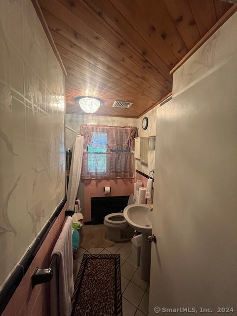 bathroom with toilet, tile patterned floors, wooden ceiling, and a shower