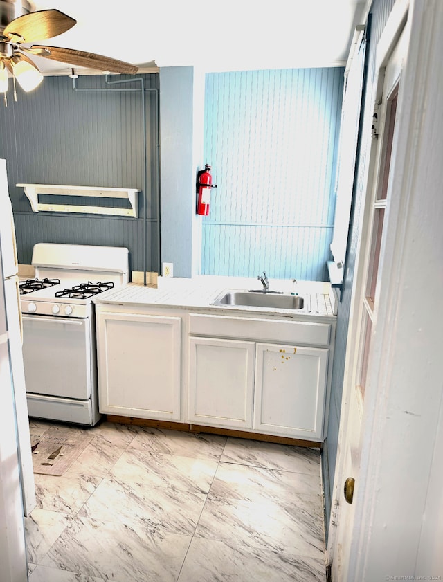 kitchen with white cabinets, sink, white appliances, and ceiling fan