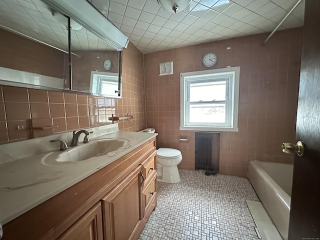 full bathroom featuring tile patterned flooring, vanity, tile walls, and toilet