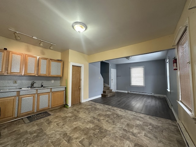 kitchen with sink, decorative backsplash, and a baseboard heating unit