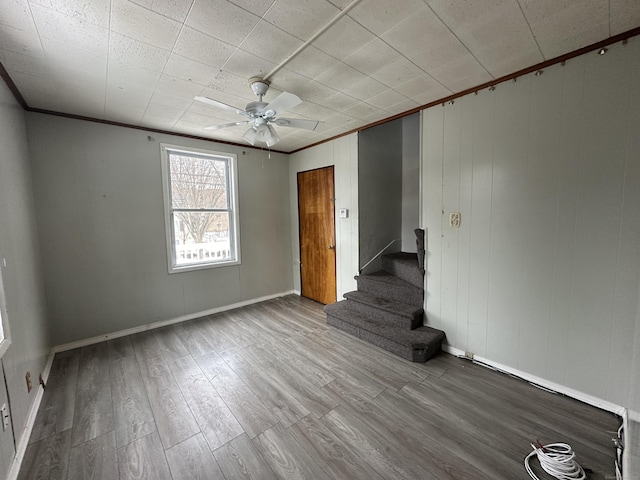 spare room with ornamental molding, ceiling fan, and light hardwood / wood-style floors