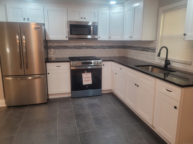 kitchen with white cabinetry, appliances with stainless steel finishes, and sink