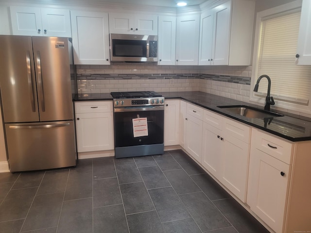 kitchen with white cabinetry, appliances with stainless steel finishes, and sink