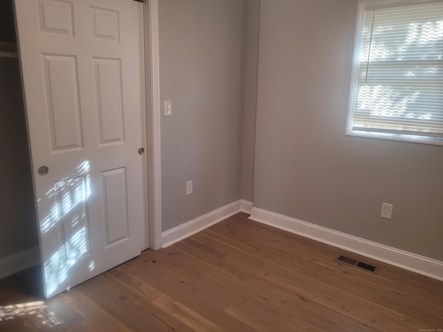 unfurnished room with dark hardwood / wood-style floors