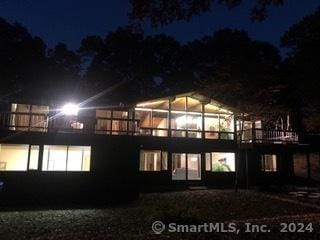 view of back house at twilight