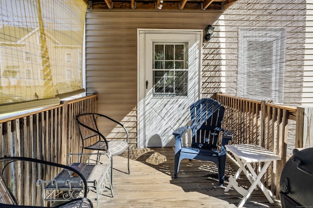 wooden balcony featuring area for grilling and a deck