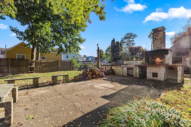 view of patio with exterior fireplace